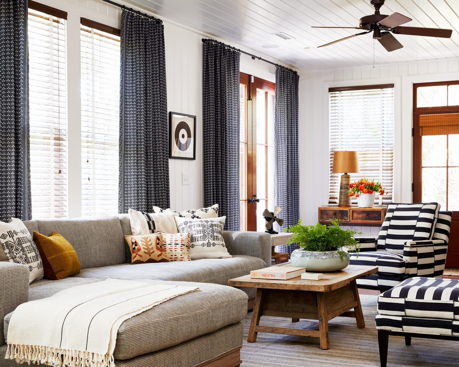 eclectic living room with striped black and white chairs