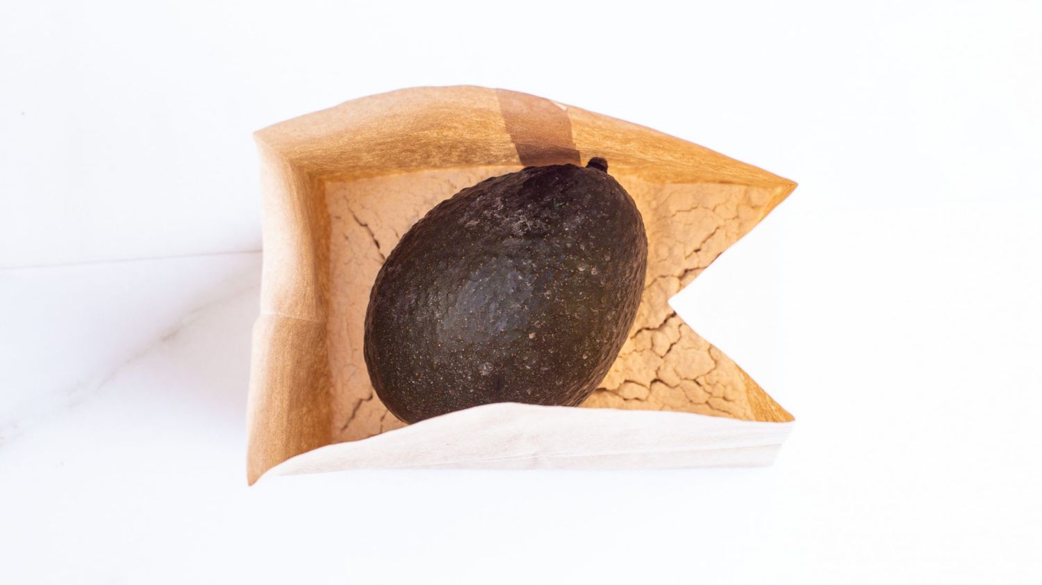 overhead view of avocado and flour in a brown paper bag