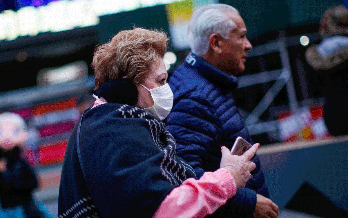 A woman wearing a mask in Times Square, New York City.