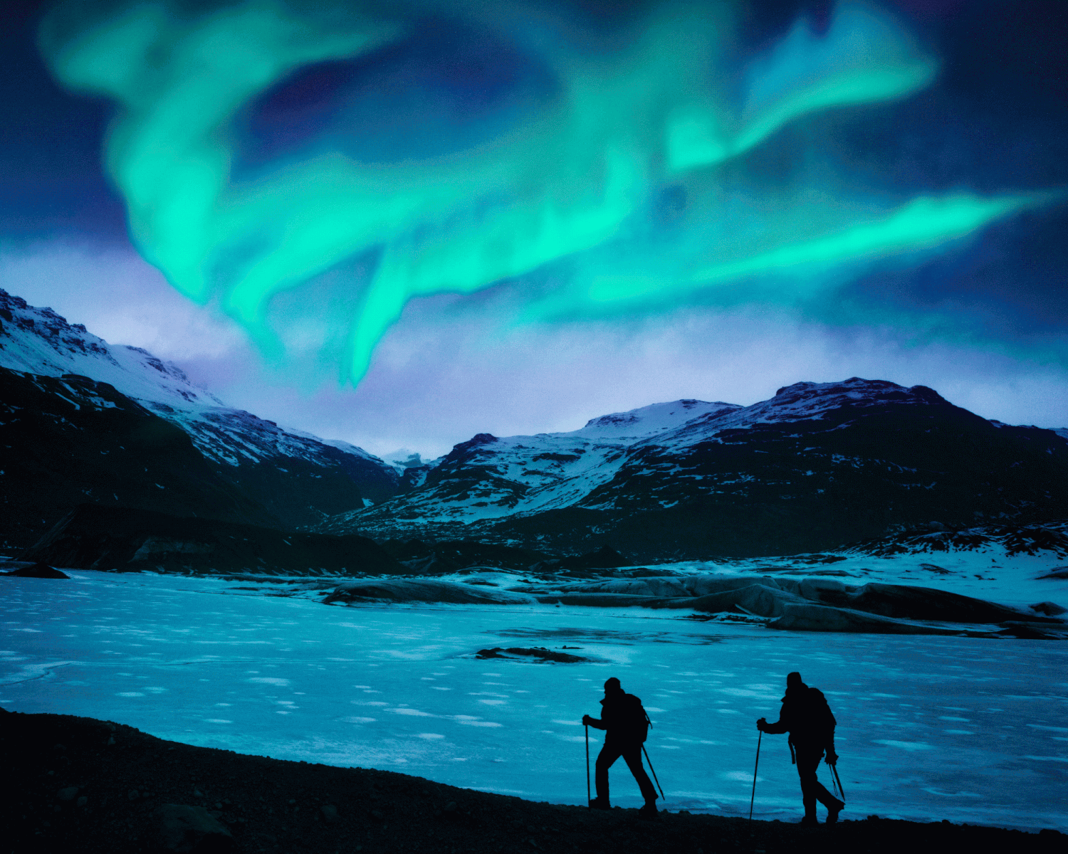 two hikers under the northern lights