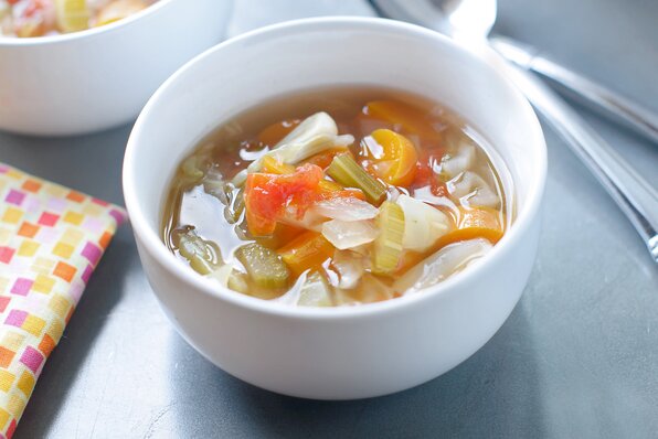 image of a bowl of cabbage soup, filled with veggies