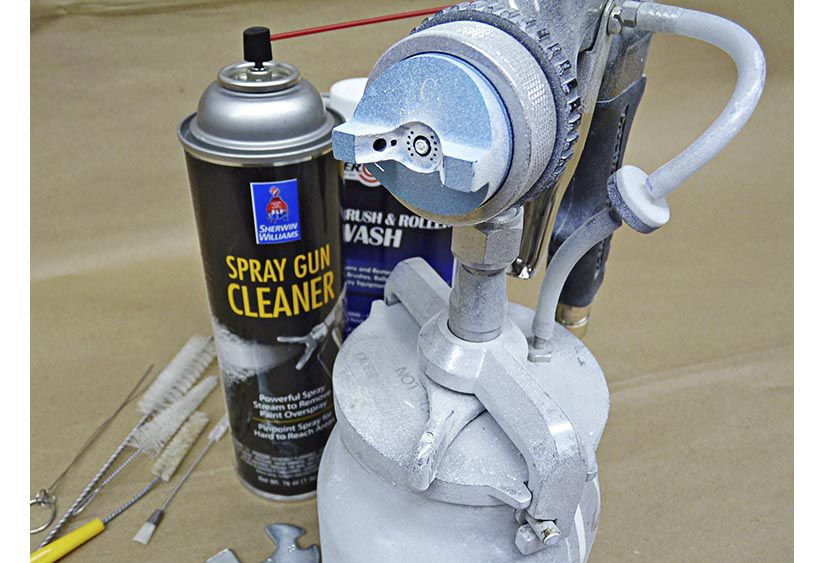 How do I clean a clogged spray gun?