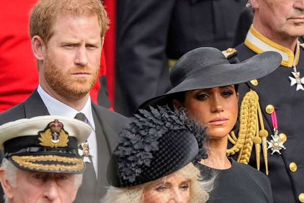 Mandatory Credit: Photo by Martin Meissner/AP/Shutterstock (13401795ar) Britain's King Charles III, from bottom left, Camilla, the Queen Consort, Prince Harry and Meghan, Duchess of Sussex watch as the coffin of Queen Elizabeth II is placed into the hearse following the state funeral service in Westminster Abbey in central London . The Queen, who died aged 96 on Sept. 8, will be buried at Windsor alongside her late husband, Prince Philip, who died last year Royals Funeral, London, United Kingdom - 19 Sep 2022