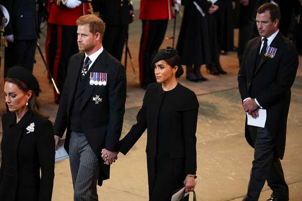 Catherine, Princess of Wales, Prince Harry, Duke of Sussex and Meghan, Duchess of Sussex and Peter Phillips arrive in the Palace of Westminster after the procession for the Lying-in State of Queen Elizabeth II on September 14, 2022 in London, England.