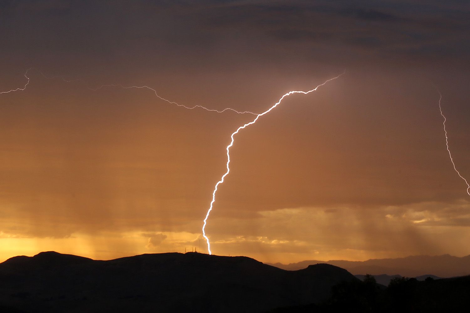Lighting strikes to the West over the Oxnard plain as seen from Thousand Oaks as rain, thunder and lightning hit the southland by surprise Monday October 4, 2021