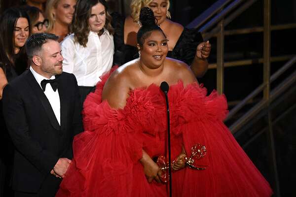 US singer-songwriter Lizzo (R) accepts the award for Outstanding Competition Program for "Lizzo's Watch Out For the Big Grrrls" onstage during the 74th Emmy Awards at the Microsoft Theater in Los Angeles, California, on September 12, 2022. (Photo by Patrick T. FALLON / AFP) (Photo by PATRICK T. FALLON/AFP via Getty Images)