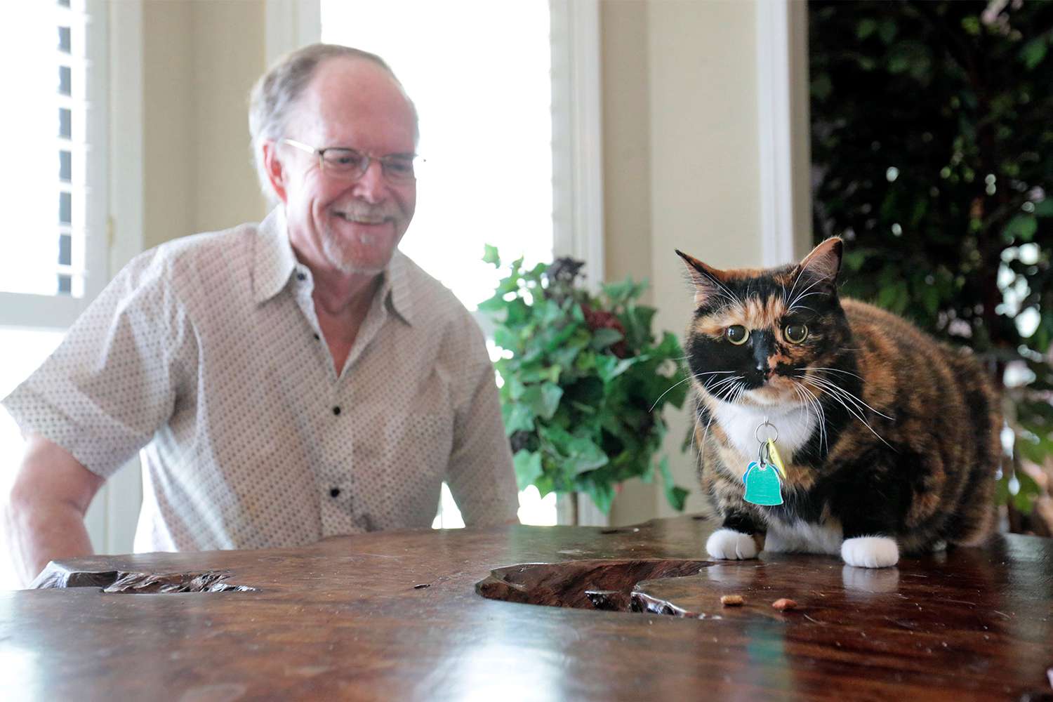 Fred Everitt of Tupelo, Miss., is all smiles after his cat, "Bandit", alerted him in the middle of the night that two men were trying to break into the back door of his home, July 29, 2022, in Tupelo, Miss.