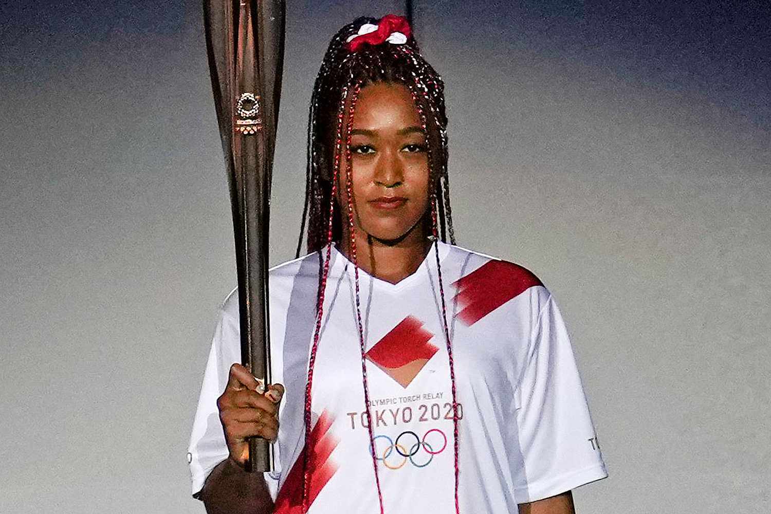 Japan's Naomi Osaka holds the Olympic torch