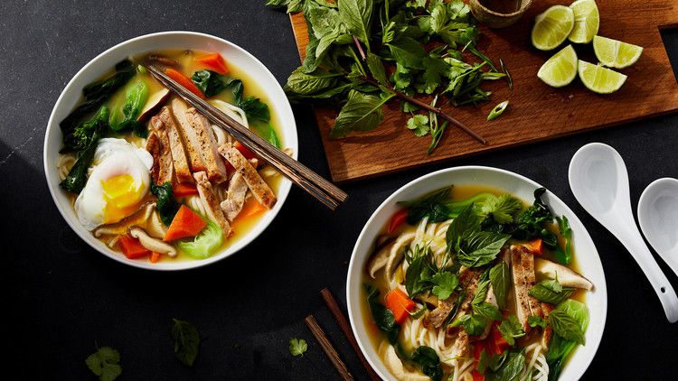 shanghai noodle soup served with mint and lime wedges