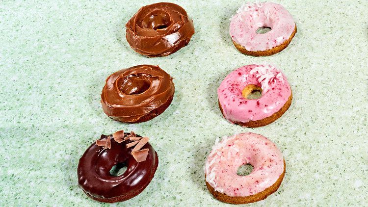 rows of doughnuts on green countertop