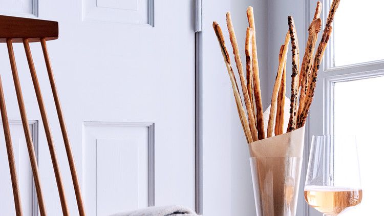 gruyere anchovy and olive straws within glass vase