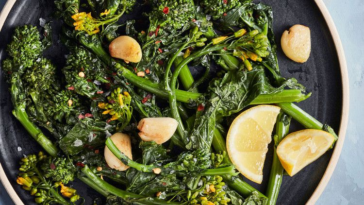 simply sauteed broccoli rabe healthy sidedish on blue table
