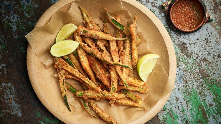spiced fried okra served with lime wedges