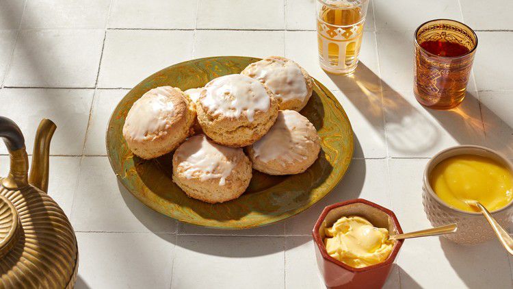 lemon ginger scones on plate next to butter dish