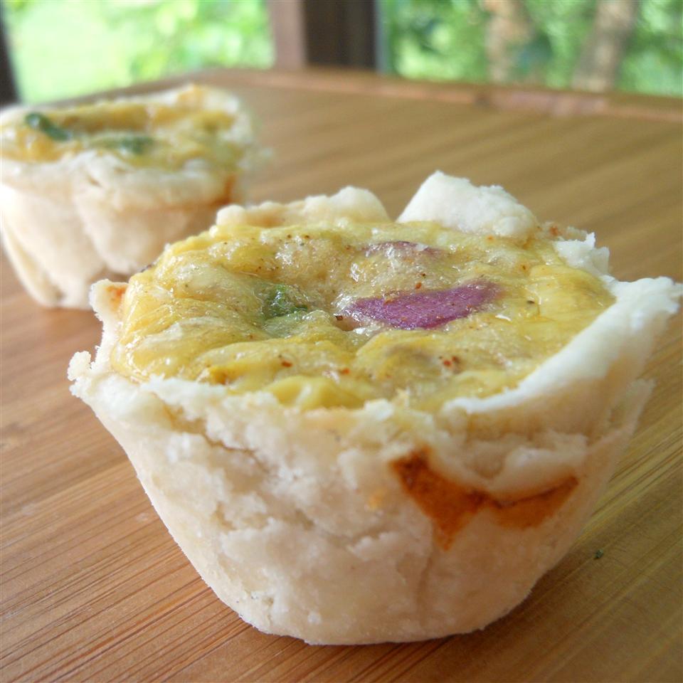 <p>Ground chorizo sausage, Monterey Jack cheese, green chiles, red onion, cilantro, and spices are added to beaten eggs and poured into prepared dough cups to create these tasty mini quiches. Serve with sour cream, diced tomato, and a drizzle of hot sauce on top.</p>
                          