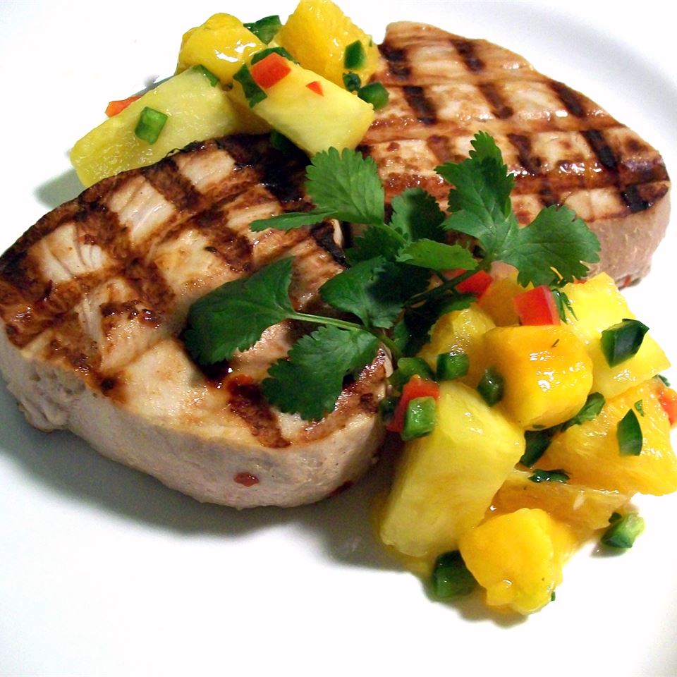 <p>This hearty swordfish steak is marinated in orange and pineapple juice, olive oil, and cayenne pepper, and finished with a salsa of oranges, mango, pineapple, and minced jalapeno. Reviewer Rebecca raves about the salsa and says she plans to use it on several other types of grilled fish this summer.</p>
                          