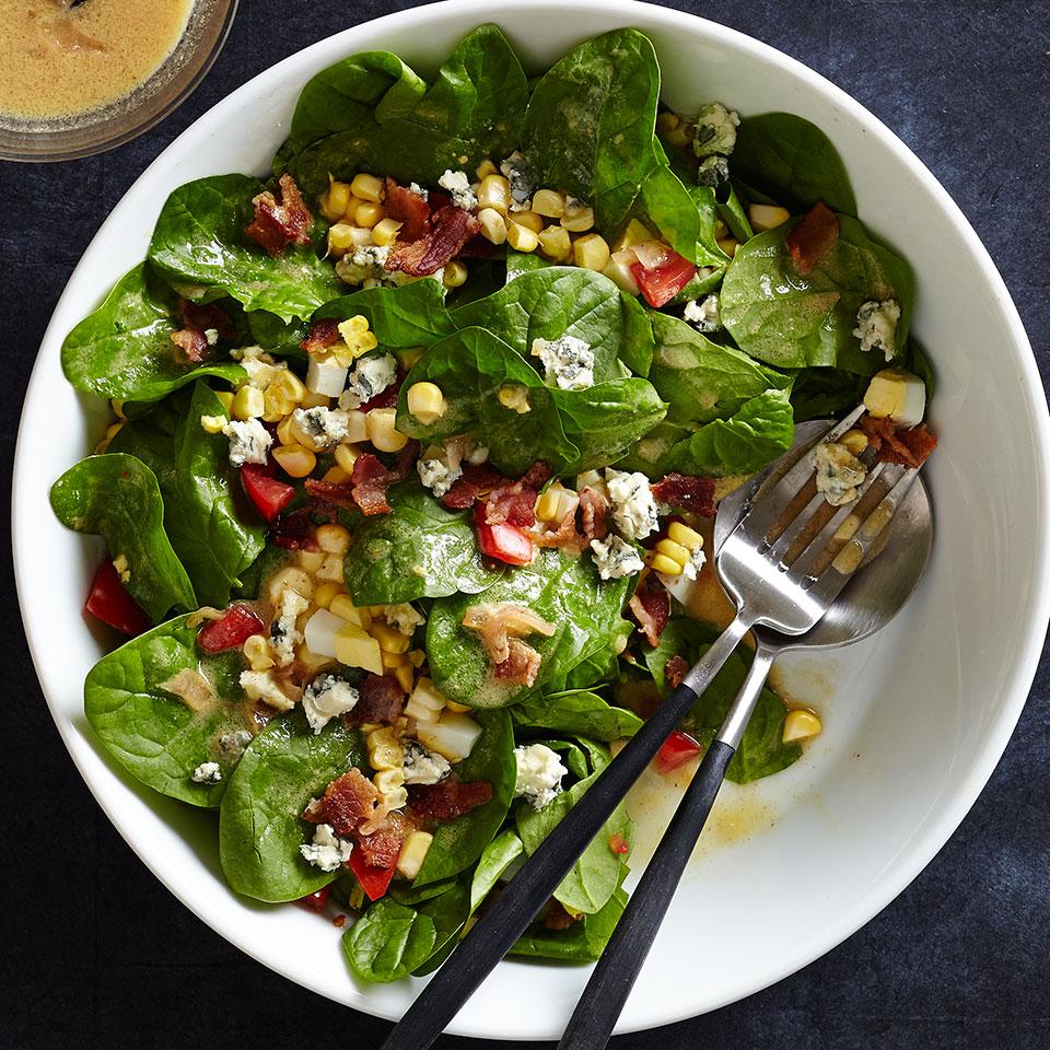 <p>This blue cheese, corn and spinach salad recipe is delicious tossed with a warm bacon-spiked tomato vinaigrette. We love a full-flavored blue cheese like Maytag, but a milder blue cheese is also nice. This spinach salad is great with pizza or as a light side salad.</p>
                          