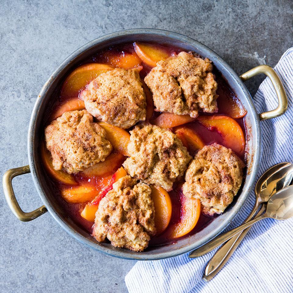 <p>Grunts, also known as slumps, are cousins to the cobbler--they too feature a biscuit topping, but unlike the cobbler, which is baked in the oven, a grunt is cooked on the stovetop. In this easy summertime dessert, apricots simmer in a skillet with honey and a touch of cloves. Then whole-grain buttermilk biscuits are steamed on top of the bubbling fruit until set. Serve warm with a little heavy cream, a dollop of yogurt or vanilla ice cream. Try it with any type of fruit or combination of fruit--frozen fruit works well too.</p>
                          