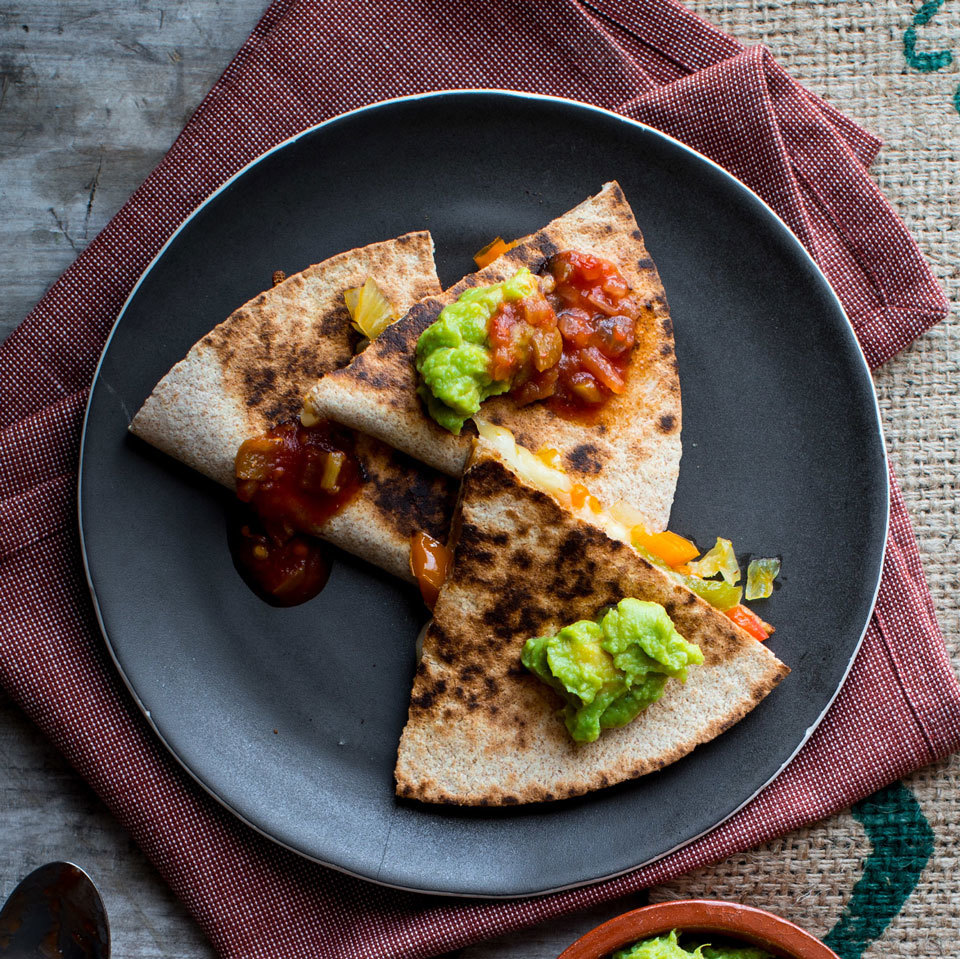 <p>These 15-minute quesadillas are a notch above basic with the addition of sautéed peppers and onions. Let the kiddos load them up with the toppings at the table.</p>
                          
