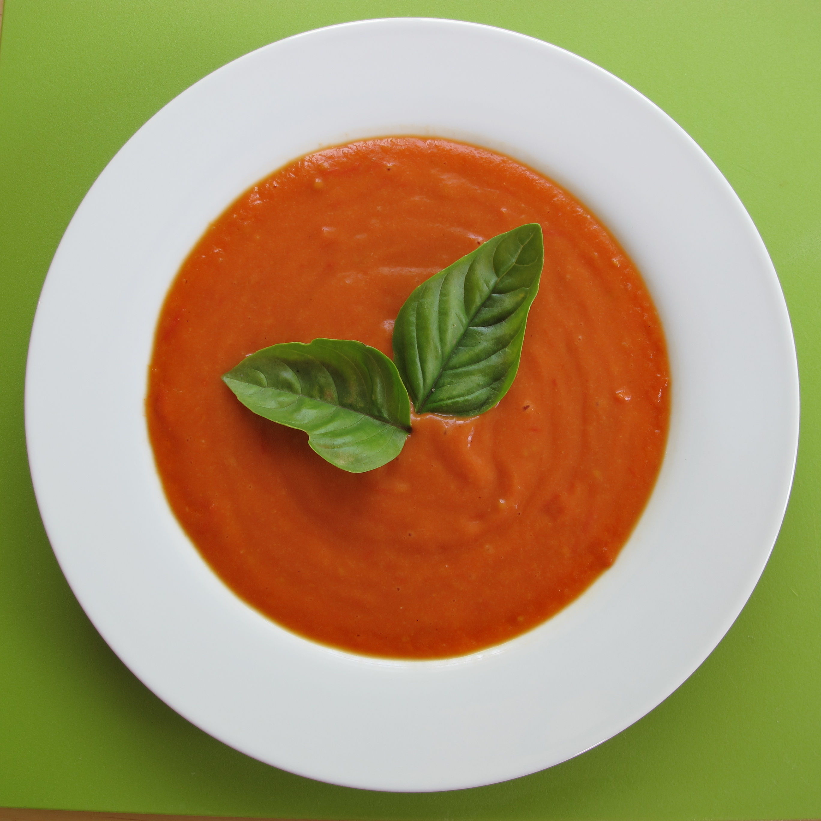 <p>In this vegan tomato soup recipe, you'll not only experience double the flavor from regular tomatoes and cherry tomatoes, but a healthy dose of vitamins and fiber from keeping the skin on as well. To really wow your dinner guests, top the finished soup with sprigs of basil leaves. </p>
                          