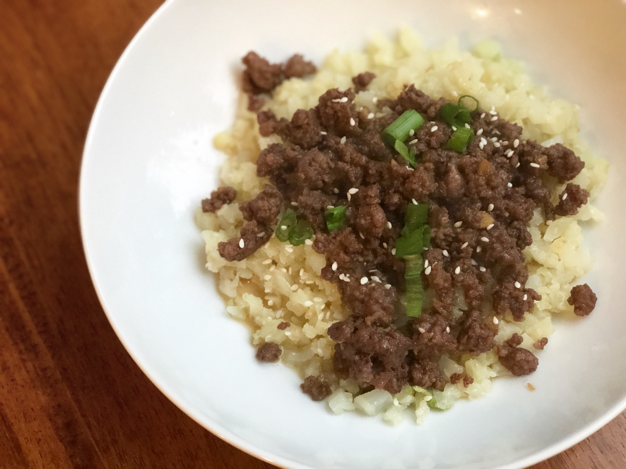 Ground beef is cooked in a soy, ginger, garlic, and black pepper sauce. Serve over cauliflower rice with green onions and sesame seeds for a low-carb Asian-inspired meal that's quick and easy and truly tasty.
                          