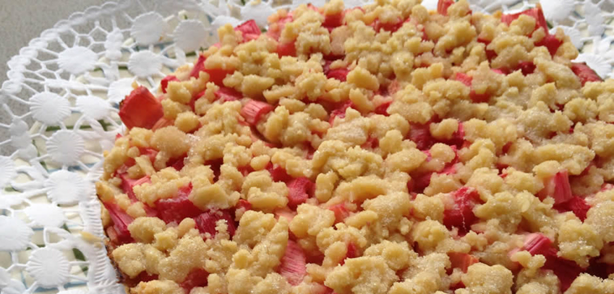 Germans really love their streusel &mdash; and by streusel we don't mean itsy bitsy crumbles but large, chunky, crunchy streusel! There is virtually no German cake with fruit of which there isn't a variation with streusel topping. Rhubarb streusel cake is especially popular because rhubarb on its own is very tart and it's only the sweet streusel that makes it the treat that it is. Interestingly, it was only after the price of sugar dropped and was no longer a luxury that rhubarb gained popularity in Germany and found its way into streusel and cakes alike.
                          