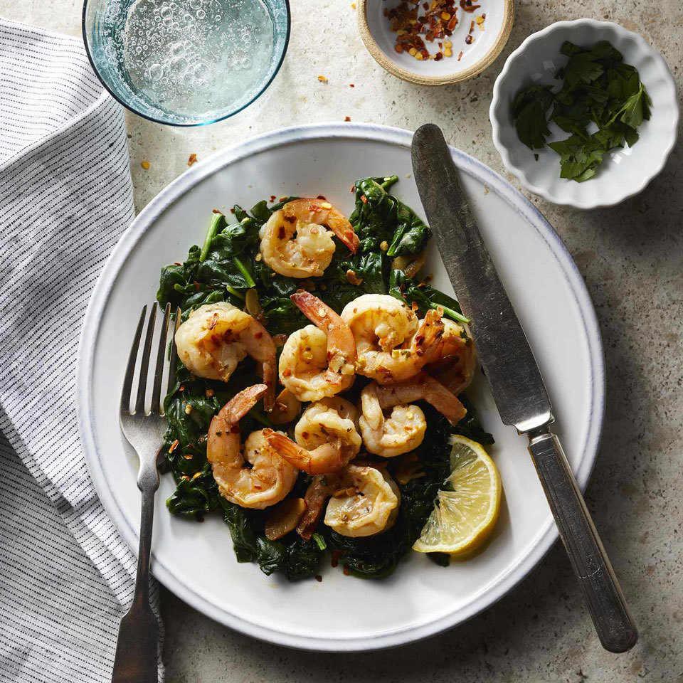 <p>Shrimp, spinach and garlic brown and cook quickly for a simple one-pot weeknight dinner. A fast pan sauce gets life from zesty lemon juice, warm crushed red pepper and herby parsley. Serve with a slice of whole-wheat baguette to swipe up every last drop of sauce.</p>
                          <p> </p>
                          