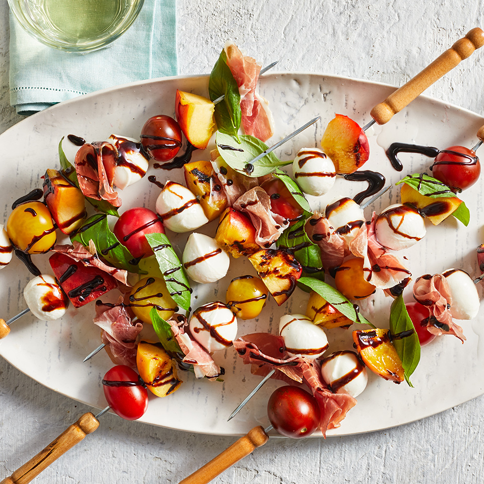 <p>These quick and easy caprese skewers are a perfect way to showcase fresh summer ingredients: mild and milky mozzarella complements sweet tomatoes, while the sweet grilled peaches and salty prosciutto add bold flavors that elevate this classic appetizer. If you're entertaining, serve these skewers on an Italian-themed snack board alongside less labor-intensive ingredients such as store-bought grissini, cheese, marinated artichokes and charcuterie</p>
                          