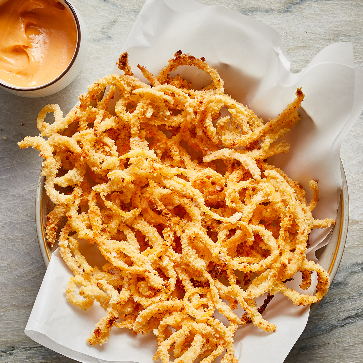 <p>Sweet spiralized butternut squash is encased in a salty, extra-crunchy exterior for a serving of slightly sweet curly fries. You can pair these baked butternut squash shoestring fries with any protein of your choice, but we're partial to grilled fish or chicken. Look for pre-spiralized squash in the refrigerated produce section.</p>
                          