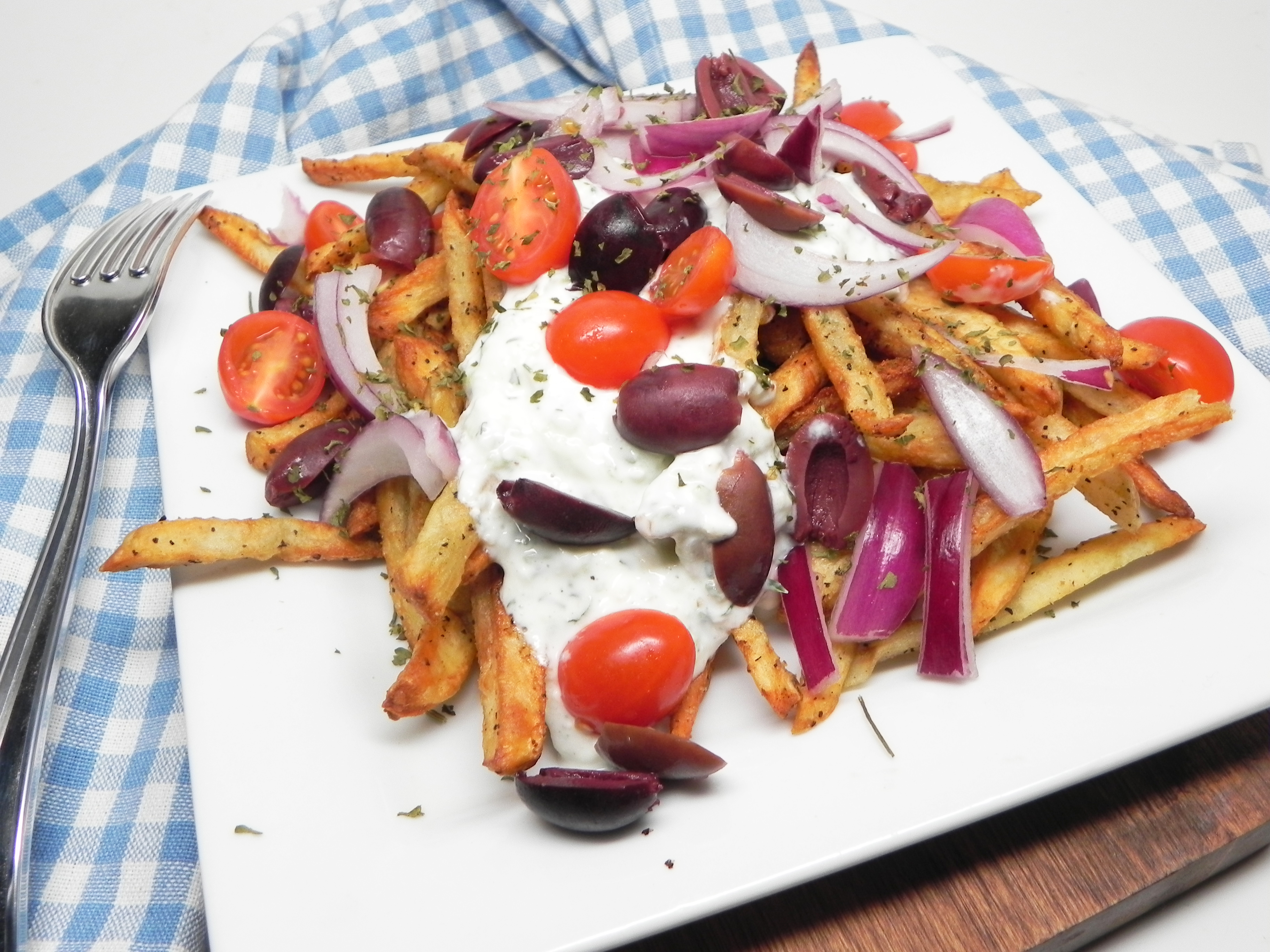 <p>It's the Greek answer to poutine! "Air-fried french fries loaded with Greek flavors," says Soup Loving Nicole. "These are great on their own but also pair nicely with lamb, steak, or chicken. Cheese is a must for loaded fries but since feta doesn't melt, I incorporated it into the tzatziki sauce."</p>
                          