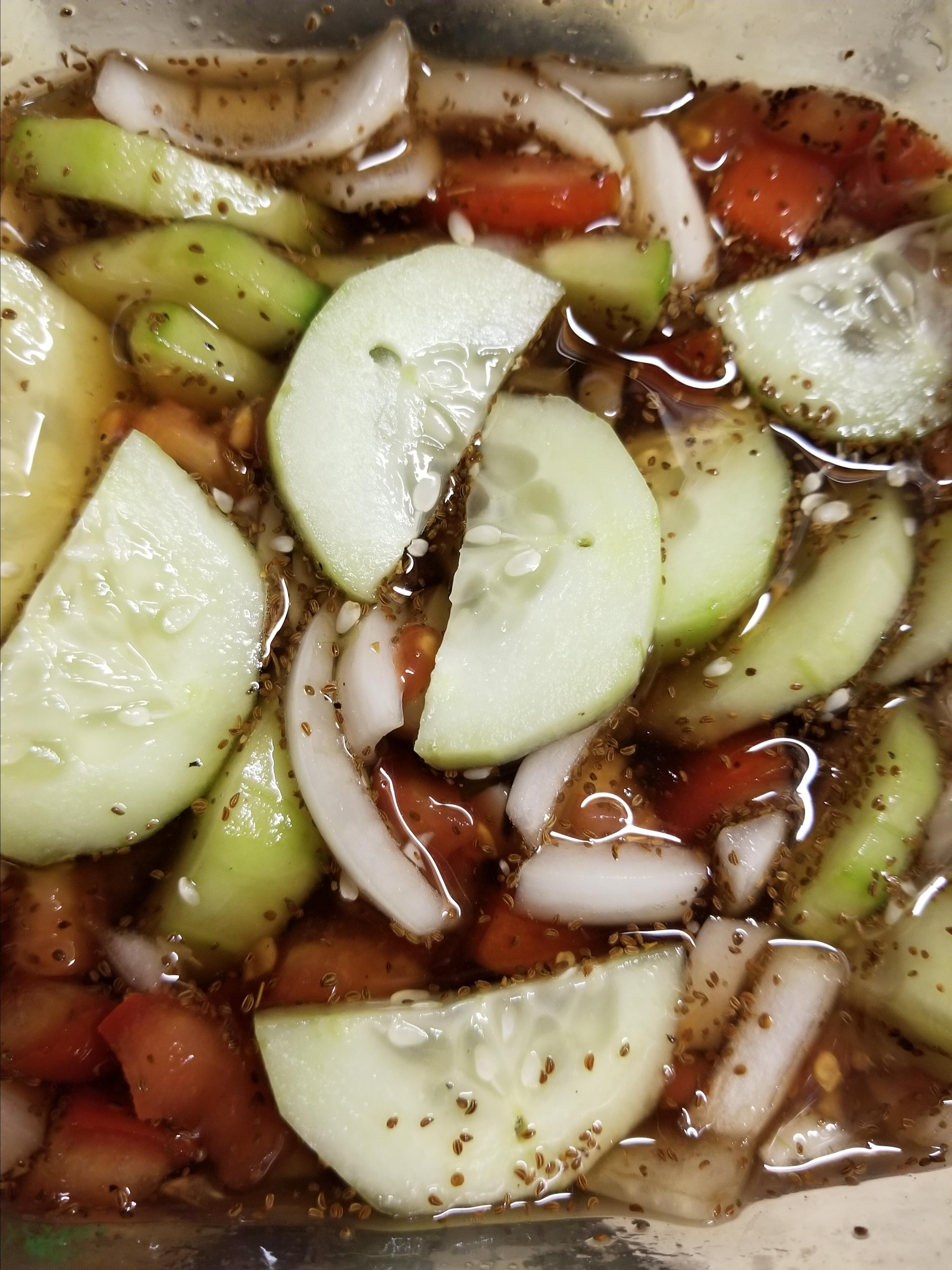 Floating Cucumber, Tomato, and Onion Salad image