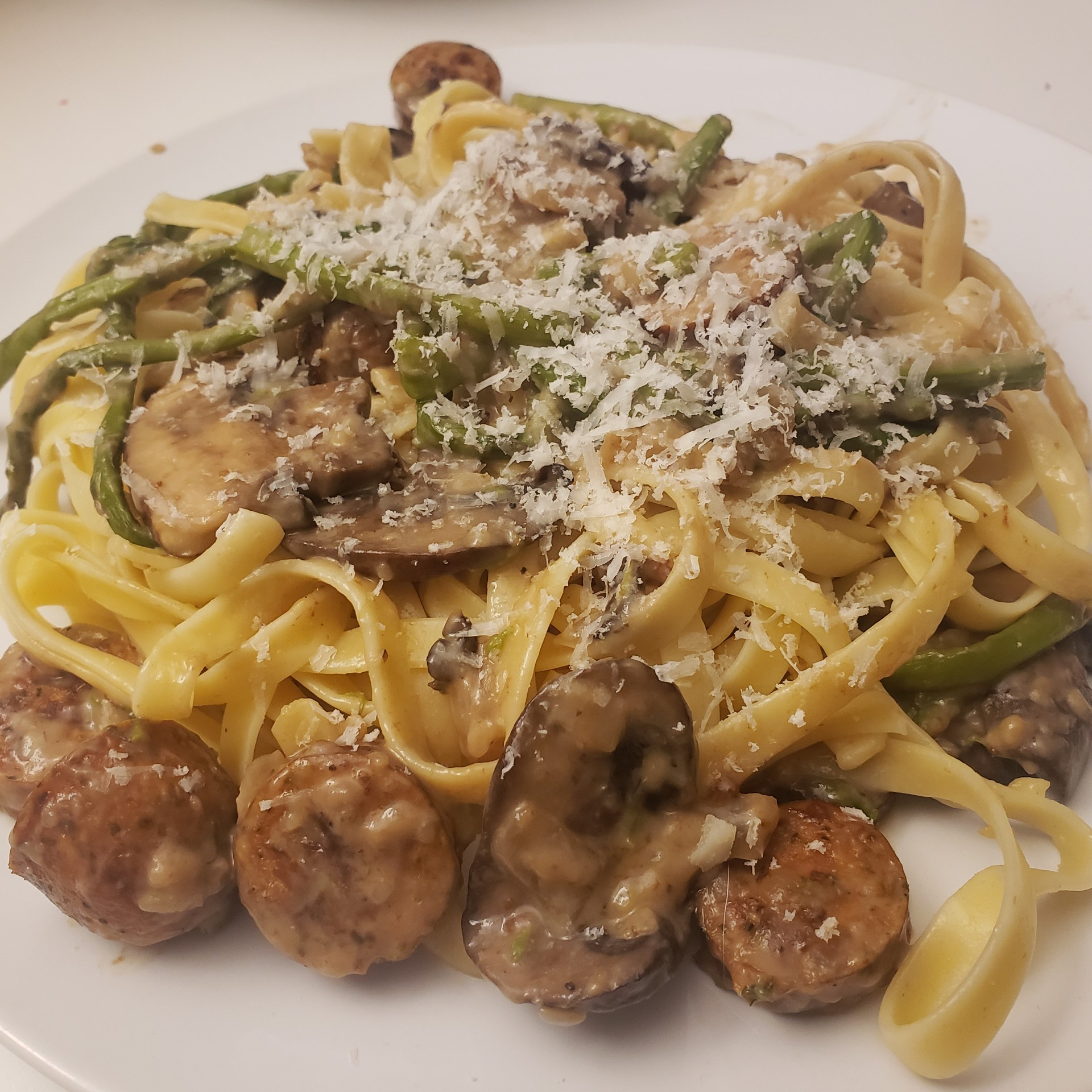 Fettuccine and Zoodles Topped with Chicken Sausage, Asparagus, and Mushrooms 