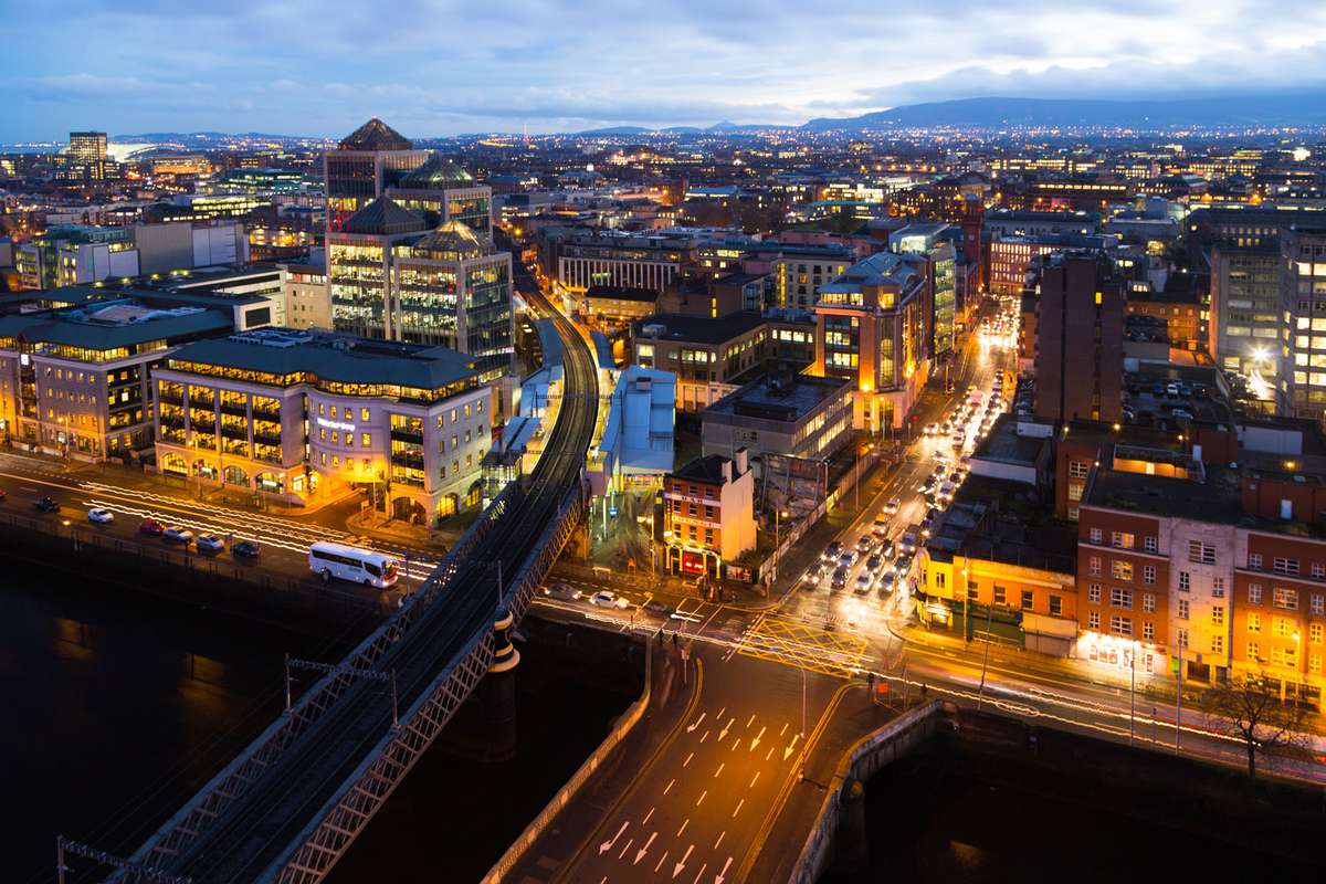 A viewpoint over the bridges along the river Liffey looking towards the Docklands area at night in Dublin, Ireland
