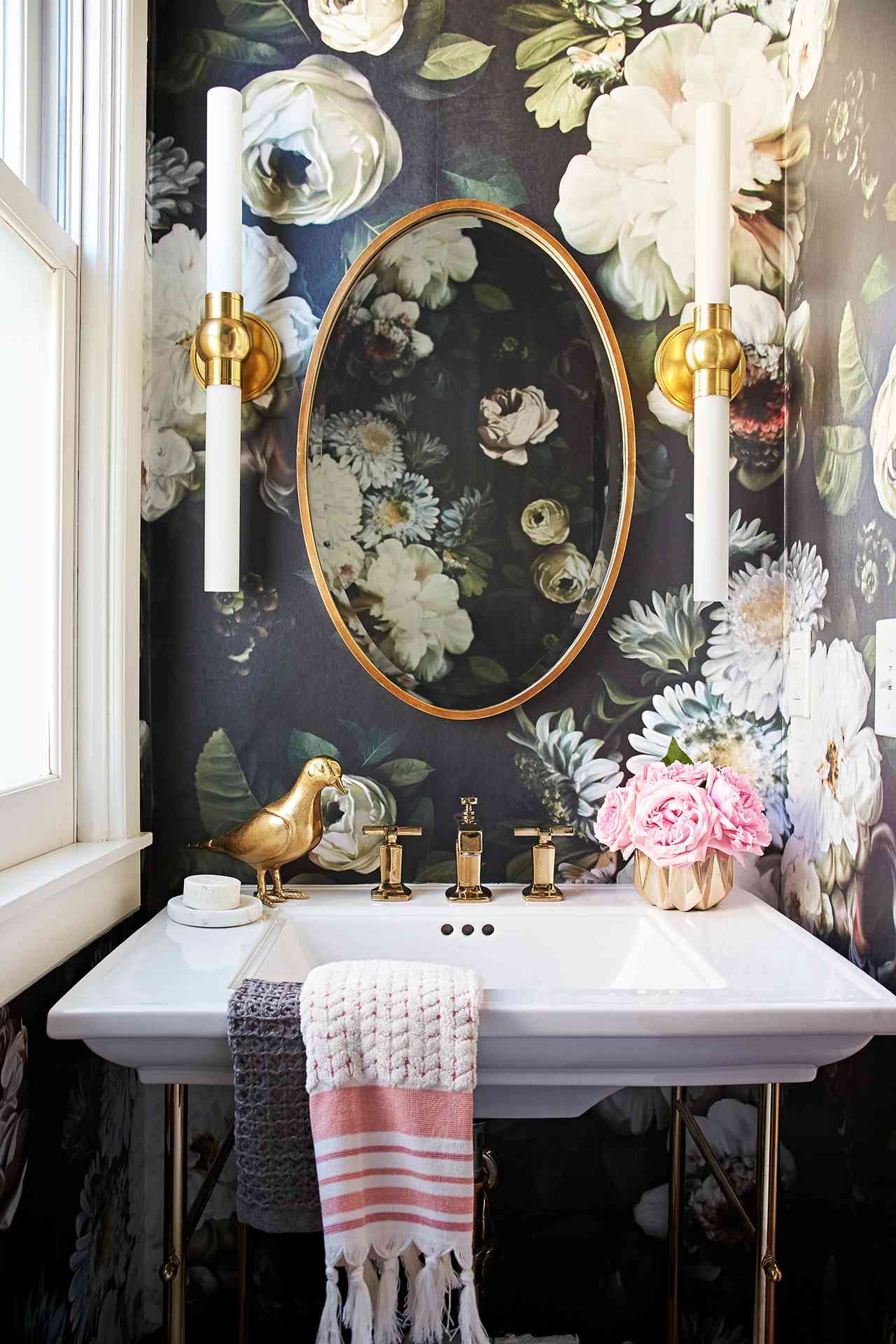 bathroom with dark floral wallpaper and white sink