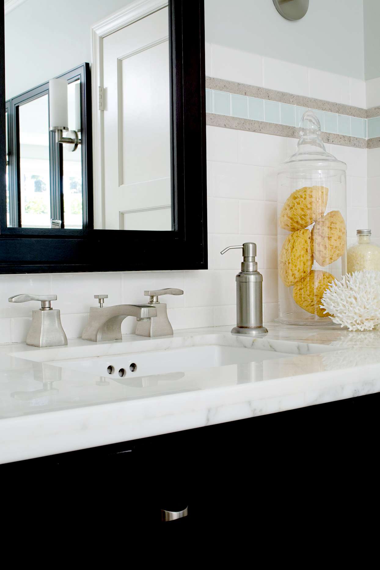 Marble bathroom sink with glass container and sponges