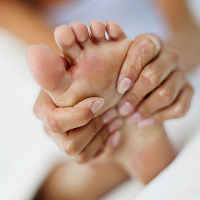 massaging-swollen-foot