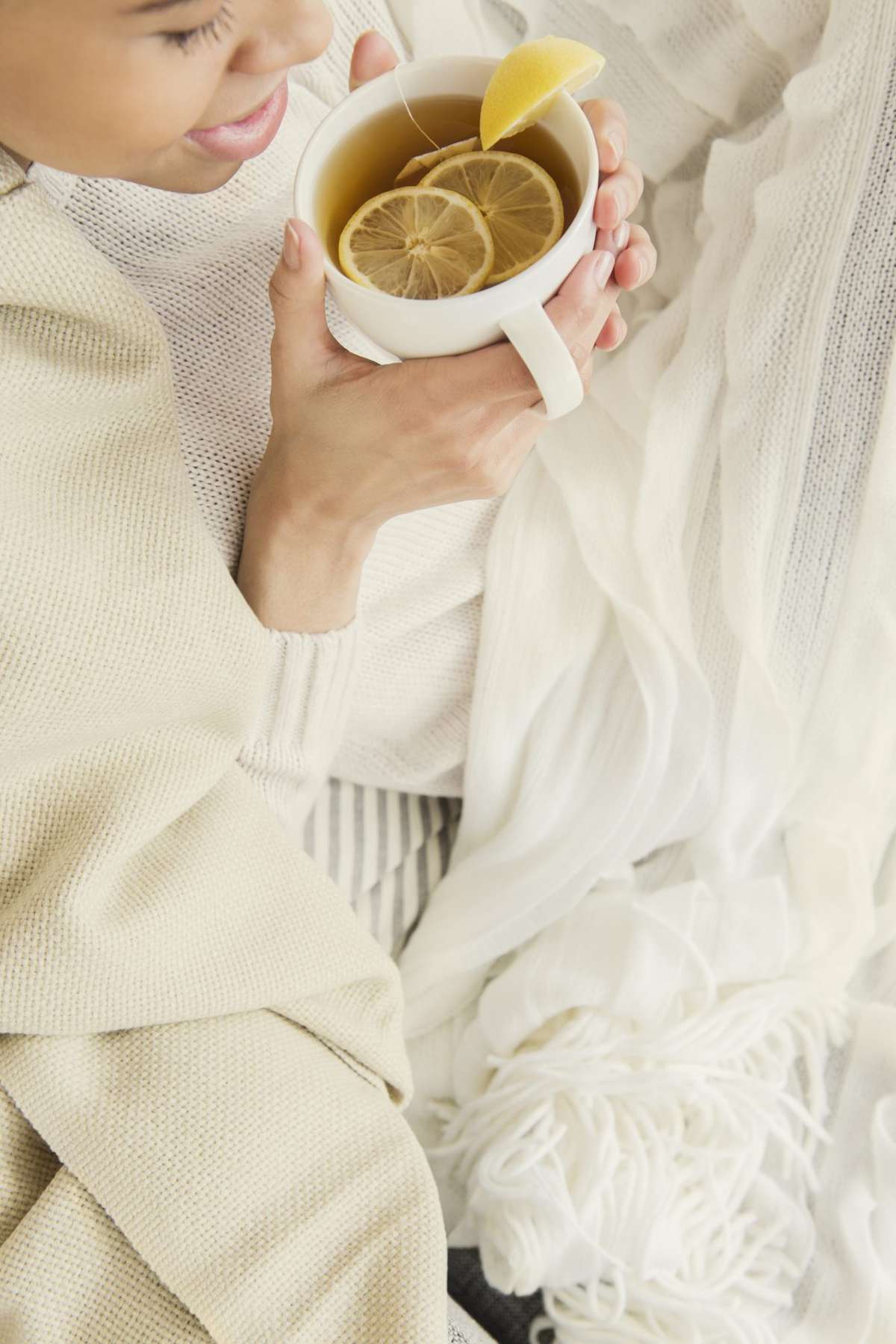 Woman drinking herbal tea with fruit