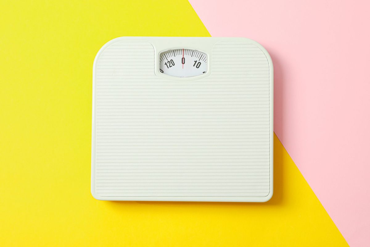White weigh scales on two tone background, space for text
