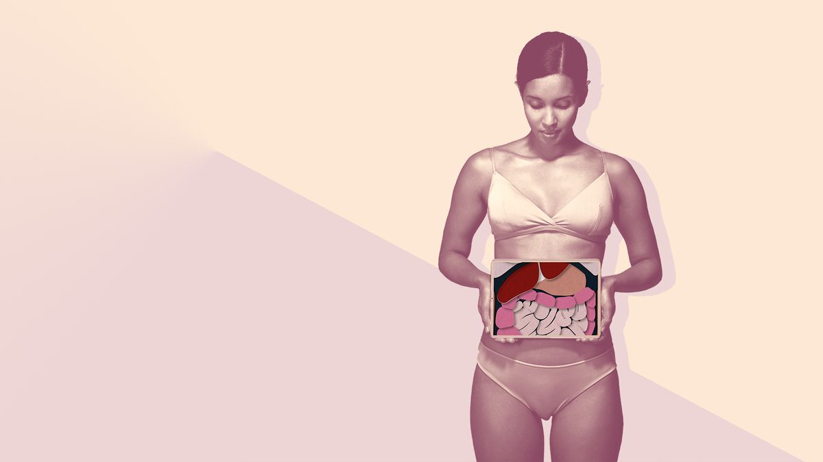 Young woman holding tablet in front of stomach to show intestines , gut-hormone-link , health-mag-may-2020