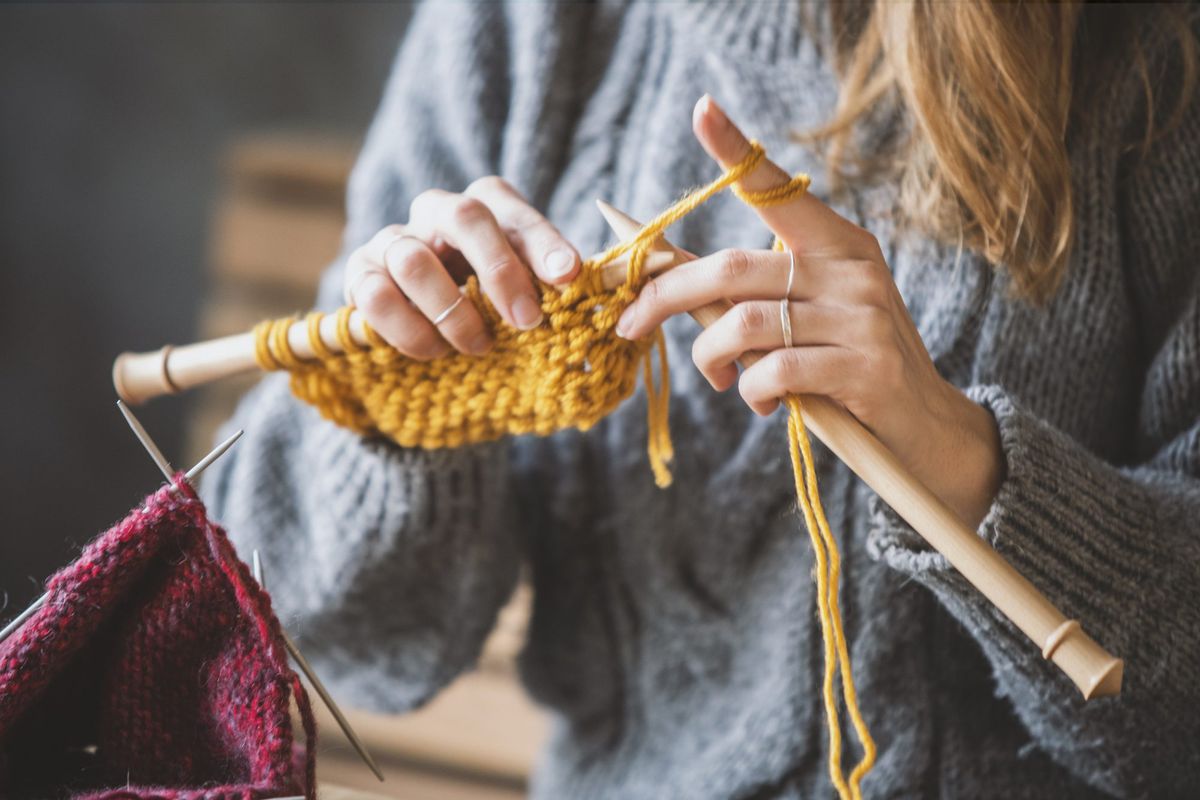 Close up on woman's hands knitting. quarantine-hobbies-knitting