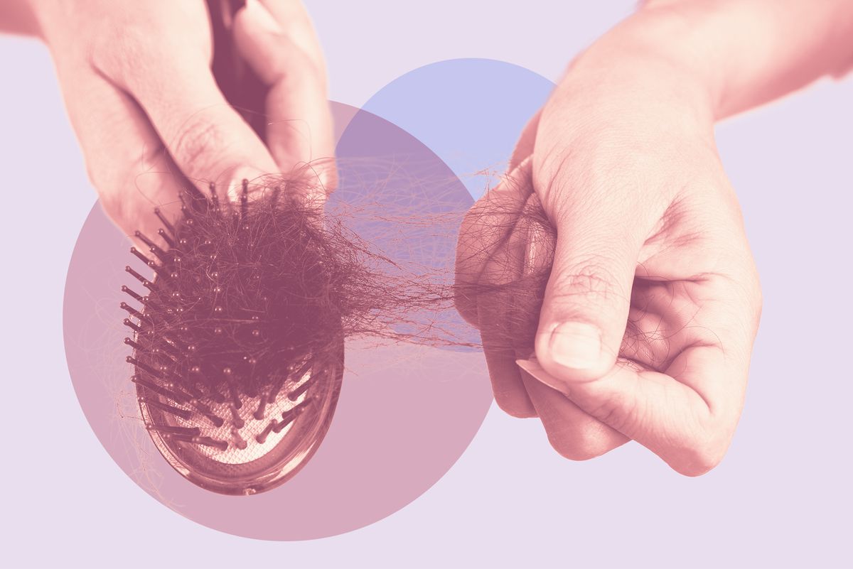 Midsection Of Woman Holding Brush With Fallen Hair