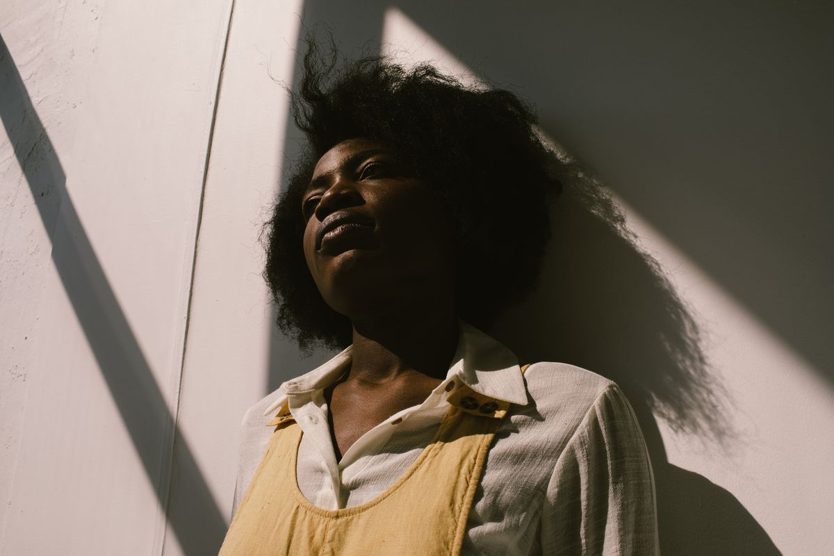 WHAT’S MAKING BLACK WOMEN SICK? , Dreamy black woman near concrete wall