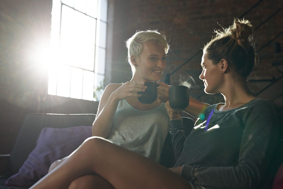 Lesbian couple relaxing and drinking tea