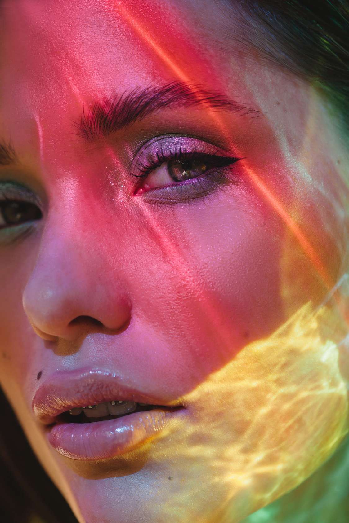 Colorful lights on woman face