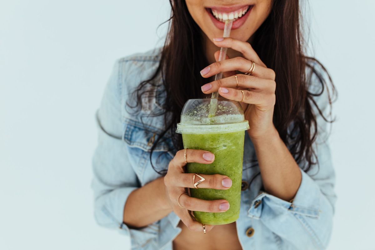 The 16 Best Blenders for Smoothies, According to Health Testers , Smiling woman drinking fresh juice