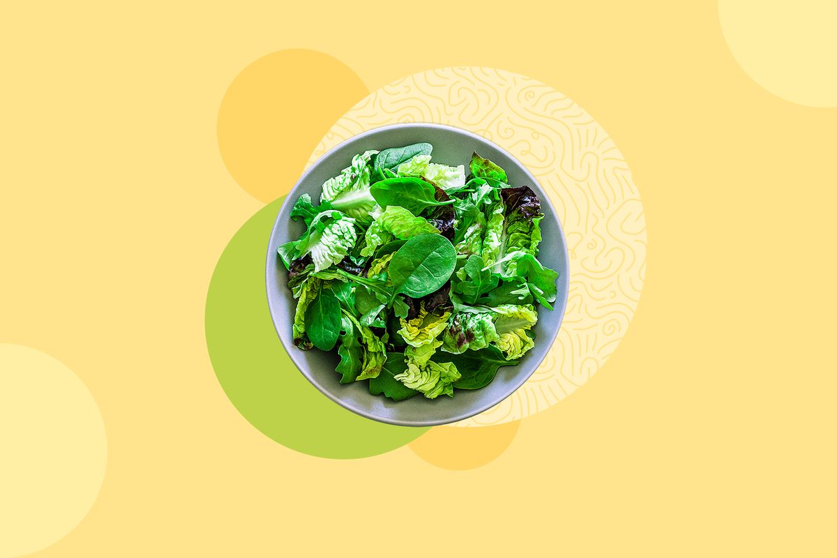 Listeria Salad Outbreak , top view of a fresh organic green salad shot on abstract background. The salad is in a gray plate and fresh ingredients like broccoli, pumpkin seeds, spinach, arugula, pistachios and asparagus are out of the plate placed directly on the background