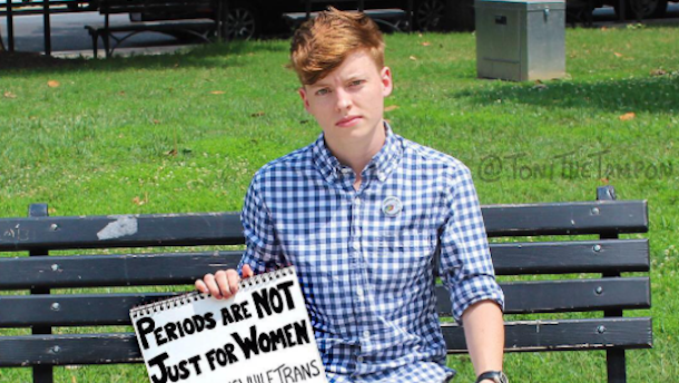 Picture of man bleeding holding a sign saying "periods are not just for women"