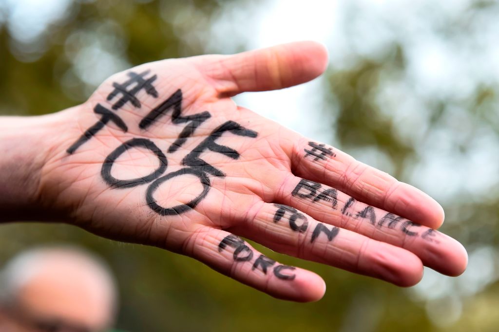 A picture shows the messages "#Me too" and #Balancetonporc ("expose your pig") on the hand of a protester during a gathering against gender-based and sexual violence called by the Effronte-e-s Collective, on the Place de la Republique square in Paris on October 29, 2017. #MeToo hashtag, is the campaign encouraging women to denounce experiences of sexual abuse that has swept across social media in the wake of the wave of allegations targeting Hollywood producer Harvey Weinstein.