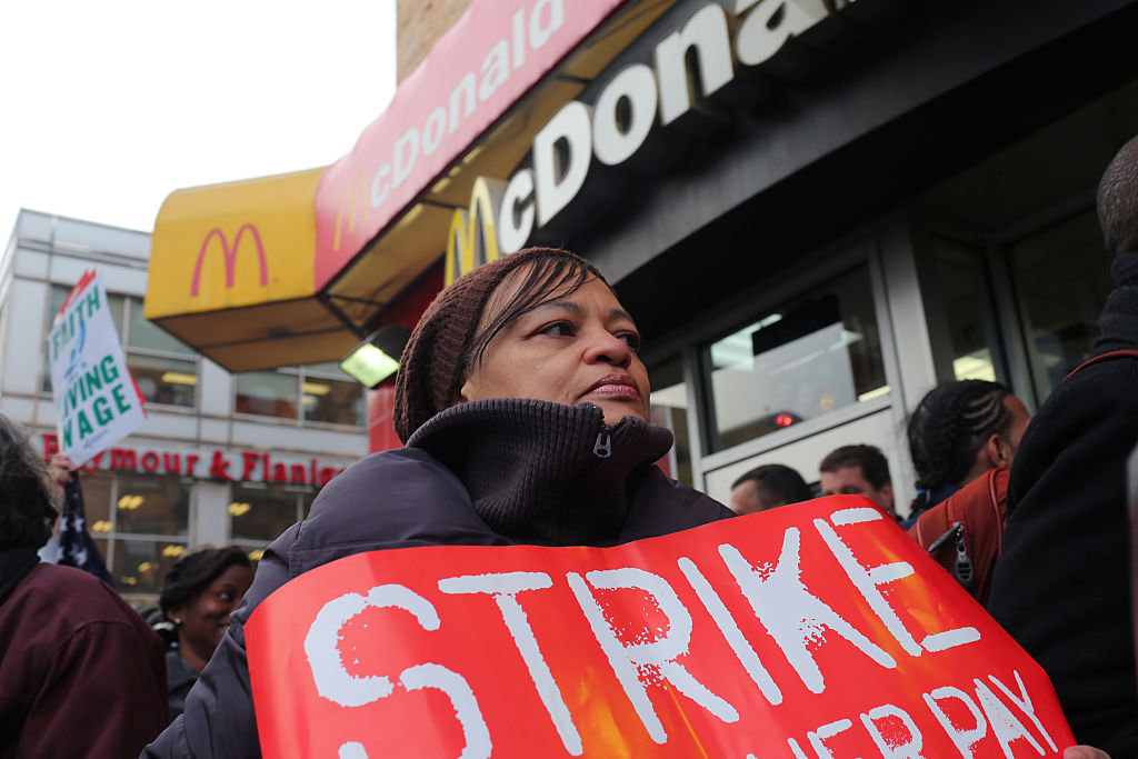 Fast food workers and their supporters participate in a one day walk out, rally, and march to a McDonald's in harlem to protest the low pay of minimum wage, saying that it $7.25 an hour in New York City is not a livable salary. Organizers estimated that several hundred fast food workers from chains across the city joined the walk out. (Photo by Andrew Lichtenstein/Corbis via Getty Images)