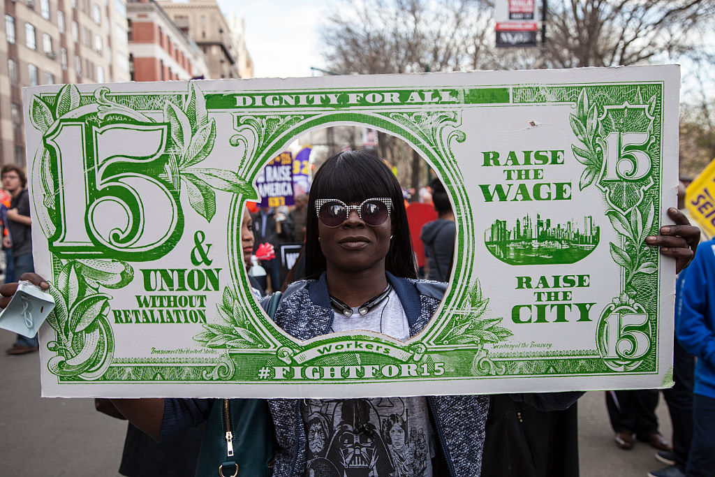 New York - 15 APRIL 2015 - A national movement of Unions and unorganized workers march to demand a raise of the the minimum wage to $15/hour, at Colombus Square in New York. (Photo by Tony Savino/Corbis via Getty Images)